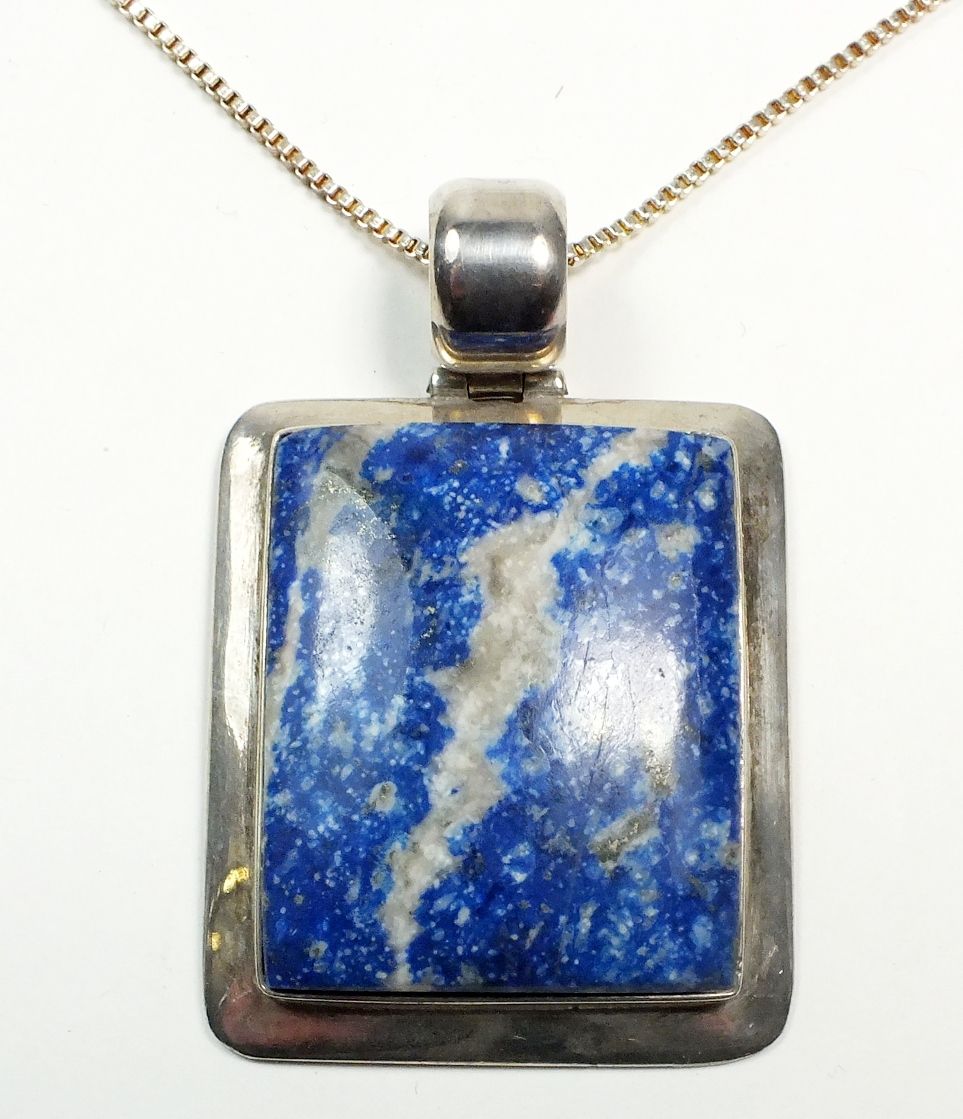 A large silver lapis lazuli pendant and silver chain