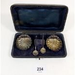 A pair of silver shell form salts and spoons, cased, Birmingham 1887