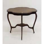 An Edwardian mahogany frill top two tier occasional table