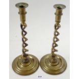 A pair of brass wrythen twist candlesticks