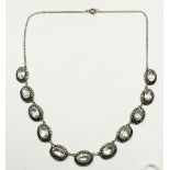 A silver rock crystal and marcasite riviere necklace with eleven links