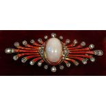 An Art Deco gold brooch set central opal within red enamel and diamond set graduated tendrils (