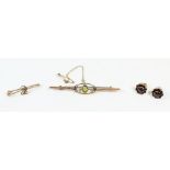 An Edwardian 9ct gold peridot and seed pearl brooch 2.5g, a yellow metal brooch and a pair of garnet