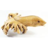 A South East Asian carved model of a fish formed from fungus wood, 21cm long