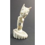 A Russian Inuit carved bone figure of Billiken, 8cm tall from Chukosk Peninsula