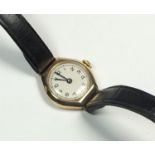 A 9ct gold ladies wrist watch with leather strap