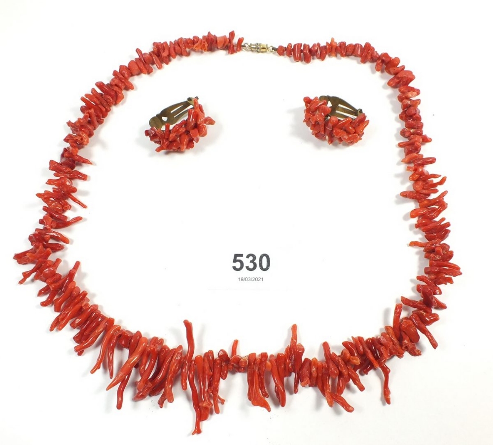 A coral necklace and a pair of clip earrings