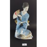 A large Japanese painted bisque figurine of a Geisha with moveable fan, artists marks to base, 33.