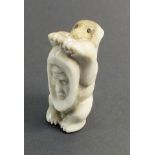 A Russian Inuit carved bone polar bear with mans face spirit to belly FM Uelen, 4.2cm
