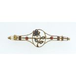 An Edwardian 9ct gold bar brooch with flower design set seed peals and coral