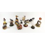 A collection of fourteen animal figurines including collies and garden birds