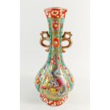 An early 20th century Chinese vase, painted dragon and butterflies on green and gilt panels, 27cm