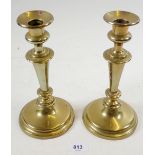 A pair of Georgian brass candlesticks