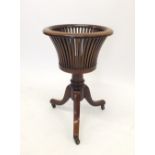 A 20th century Regency mahogany basket form plant stand on turned column and splay supports