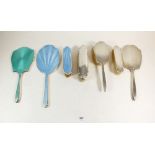 Two silver and enamel hand mirrors, a silver hand mirror, four various silver and enamel brushes and