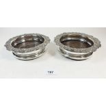 A pair of 19th century silver plated and turned wood bottle coasters with vines to border