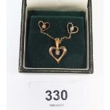 A 9ct gold diamond set heart form pendant and earrings