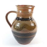 A Winchcombe Sidney Tustin jug, rim a/f, 21cm tall