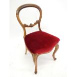 A Victorian mahogany balloon back chair carved shell all raised on cabriole supports