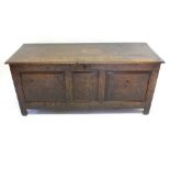 A tall rustic late 17th or early 18th century oak coffer with panelled decoration, 120cm wide x 55cm