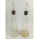 A pair of tall tapered glass decanters with silver collars, 3.7cm, one with crack, a/f