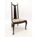 An Arts and Craft nursing chair with tapered back, 96cm tall