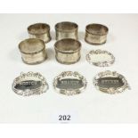 A set of 5 silver plated napkin rings together with 4 decanter labels