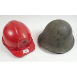 A British Army Mk IV Turtle helmet together with a red GPO hard hat