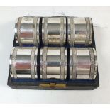 A set of six silver plated napkin rings, cased
