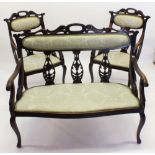 A French Art Nouveau mahogany three piece salon suite with decorative carved frame