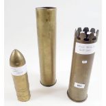 A 1943 trench art shell case together with a castellated rim one and another large shell case and