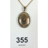 A 9ct gold locket pendant with central diamond chip, on fine chain, 4.2g. Locket size 1.8cm wide