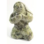 A Canadian Inuit carved green stone group of Mother with child on her back, signed, 11cm from