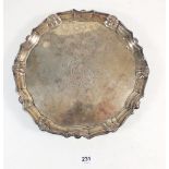 A George II silver salver with shell and scroll border and engraved cartouche to centre all raised