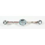 An aquamarine and diamond set bar brooch, 6.2cm (unmarked - 18ct white gold or platinum)