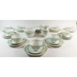 An early 20th century green printed tea service, to include 9 cups, 10 saucers, 10 tea plates, 3