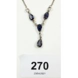 A silver and pear drop tanzanite necklace
