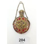 A 19th century continental gilt metal over cranberry glass pendant scent bottle decoration birds and