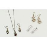 A silver and garnet Celtic style pendants and earrings - boxed, a pair of silver earrings and one