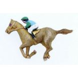 A 9ct gold horse and jockey brooch with enamel decoration and ruby eye by Crop & Farr, 8g - 3.2cm