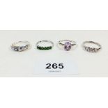 Four silver dress rings