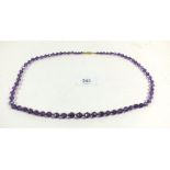 An amethyst bead necklace with silver gilt clasp