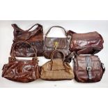 Six large brown leather handbags