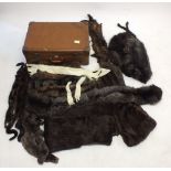 A vintage suitcase and contents of fur stoles and collars including mink
