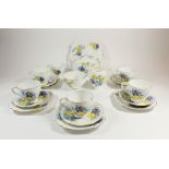 A 1930's tea service printed pansies comprising: six cups and saucers, teapot, cake plate, jug,