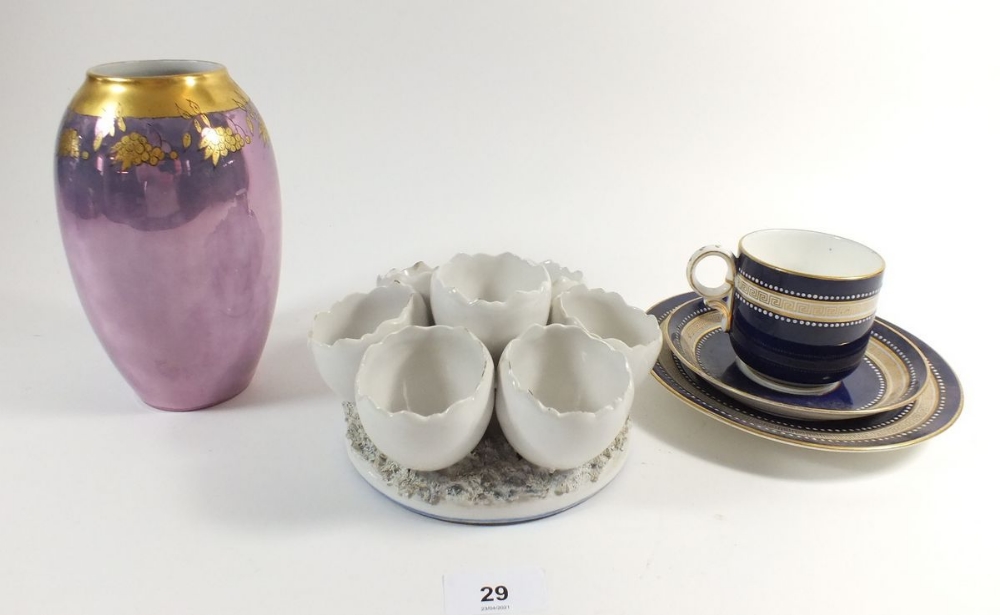A Bavarian purple lustre vase, a blue and gilt cabinet trio and an egg stand