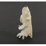An Inuit carved bone polar bear/fish spirit, 4cm from Qaanaaq