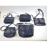 Five navy blue leather handbags