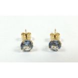A pair of 9ct gold and pale blue stone earrings