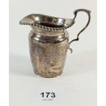 A small silver cream jug, 8cm tall, London 1908, 53g